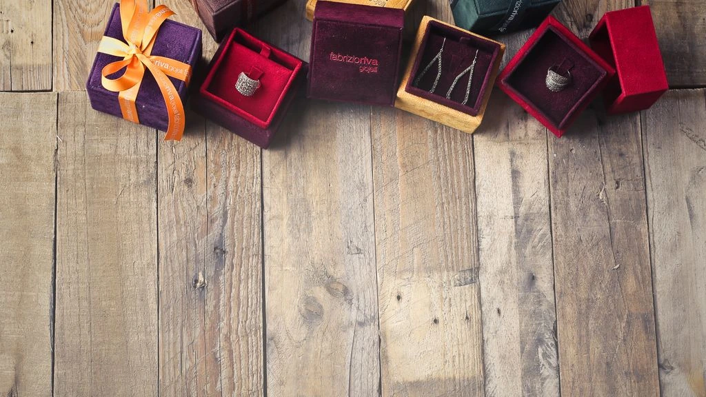 An overhead view of a holiday hamper assembly in progress on a kraft worktable.