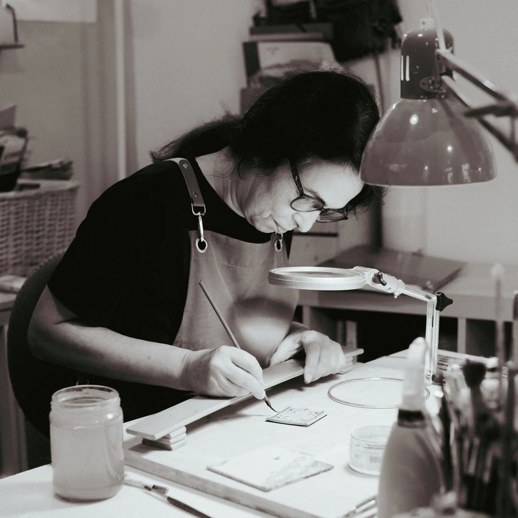 A maker portrait in a sunlit ceramics studio.